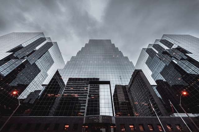 Tall glass buildings against stormy sky